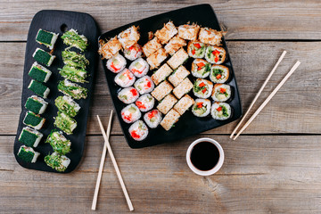 Japanese traditional restaurant menu, appetizing food. Appetizing sushi plate served with sauce and chopsticks, copy space