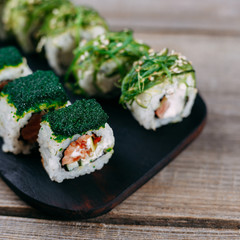 Japanese restaurant menu, professional culinary, traditional meals. Delicious sushi rolls with caviar, salmon and philadelphia cheese, close up. Delicious meals for foodie