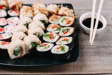 Japanese food, seafood restaurant, traditional cuisine. Great assortment of tasty appetizing maki sushi rolls, selective focus