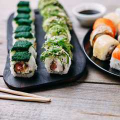 Japanese food, seafood restaurant, traditional cuisine. Great assortment of tasty appetizing maki sushi rolls, selective focus