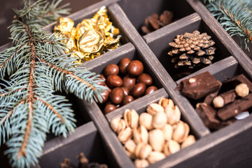 Decorative wooden box with hazelnuts,mandarins and gifts.