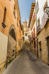 Street leading to a church tower in Tudela, Spain