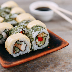 Restaurant menu, Japanese traditional meals, healthy food. Appetizing maki sushi rolls set served on original clay plates