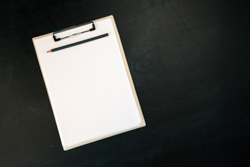 Notes clipboard with pencil and blank sheets of paper