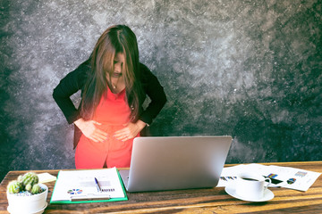 close up of  young business woman having stomach ache or Chronic gastritis, ulcer,in office, Abdomen bloating,  healthy concept.