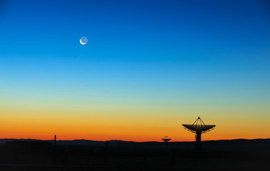 The silhouette of a radio telescope