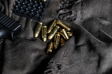 Full metal jacket 9mm ruger bullet on cloth texture