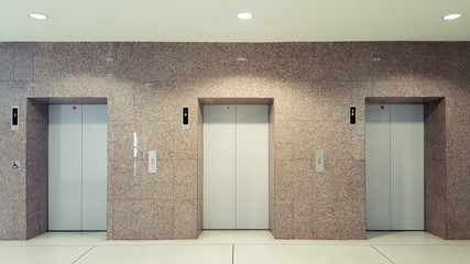 Open and closed chrome metal office building elevator doors realistic photo. Lift transportation floor to floors with push switch for up and down. Elevator disabled © santipong