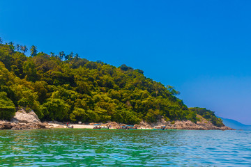 Overview of Rawa beach (Pulau Rawa), near Perhentian Kecil in Malaysia. Surrounded by rocks and forest, Rawa beach is a popular snorkelling destination for tourists which are brought by motorboats.
