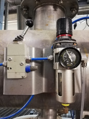 Air pressure guage regulator and toggle switch in a factory