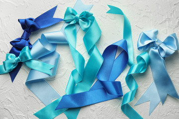 Blue satin ribbons on light table