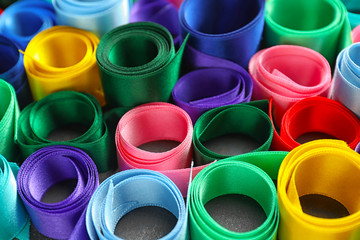 Different satin ribbons on table, closeup