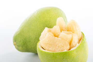 fresh and peeled pomelo(shaddock), grapefruit with slices isolated on white background