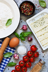 Ingredients for cooking Italian pasta: flour, egg, cheese and spices. Italian food background with space for text.