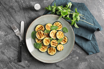 Tasty grilled zucchini on grey plate