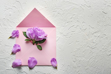 Open mail envelope with flower on light background