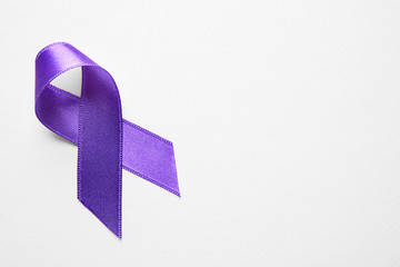 Purple ribbon on light background. Cancer concept