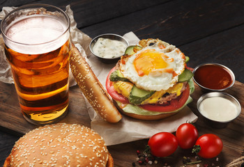 Hamburger made of beef and beer on wooden cutting board