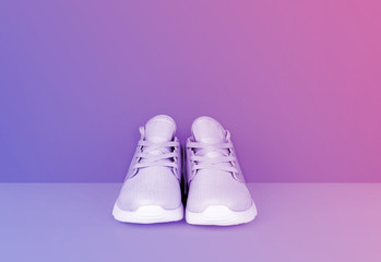 Shot of sneakers in vibrant gradient holographic colors.