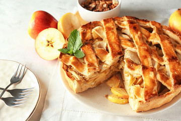 Plate with delicious apple pie on white table, closeup