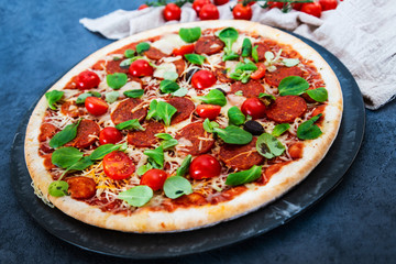 Sausage Pizza with Ham and tomatoes