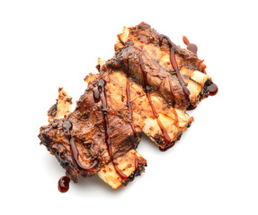 Delicious grilled ribs with sauce on white background