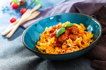 tasty fusilli pasta Italian meat sauce pasta on the table