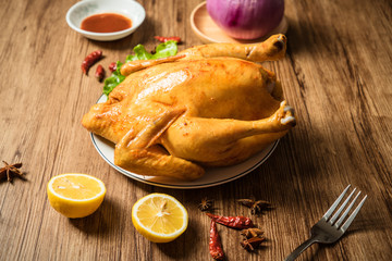 Roast chicken on the wooden table