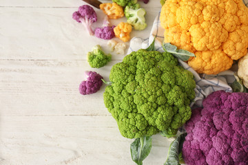 Different cauliflower cabbage on white wooden table