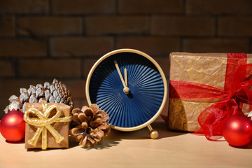 Alarm clock with gifts on table. Christmas countdown