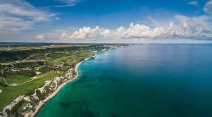 Aerial drone view of a golf course next to the cliffs and Black sea. Golfing fields landscape