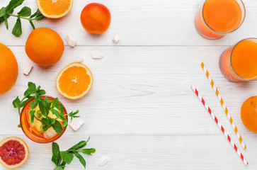 Fresh orange juice with fruits on wooden table