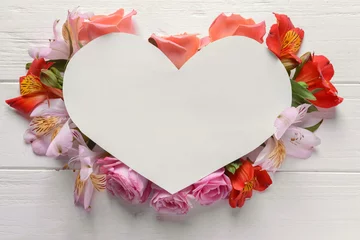 Tuinposter Heart shaped sheet of paper with beautiful flowers on white wooden background © Pixel-Shot