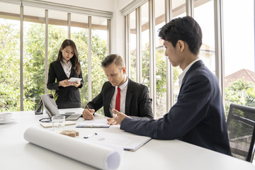 Young business man signing contract in meeting room.