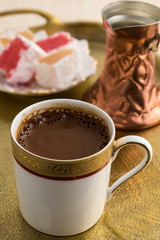 Vintage cup of turkish coffee and turkish delights served in bronze tray