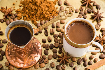 Vintage cup of turkish coffee and traditional bronze coffee pot served in bronze tray with roasted coffee beans, anise stars and cinnamon