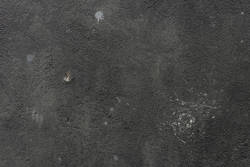 Black grunge cement wall for use as a background