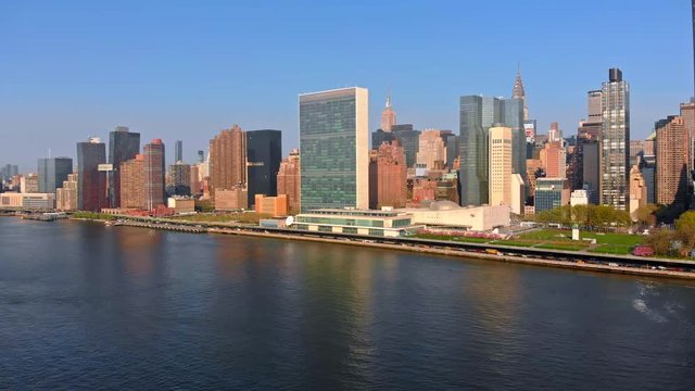 Aerial Drone Footage of New York City flying towards Manhattan skyline over East River viewed from Gantry Plaza State Park in Long Island City Port 4k