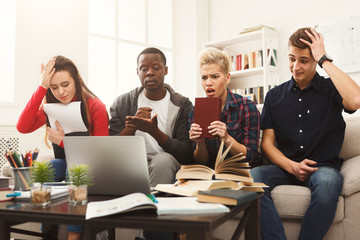 Group of diverse students studying at home atmosphere on the cou