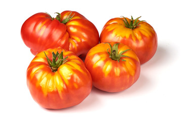 Fresh colorful sweet rustic tomatoes, isolated on white background.