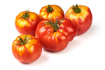 Fresh colorful sweet rustic tomatoes, isolated on white background.