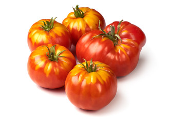 Fresh colorful sweet rustic tomatoes, isolated on white background.