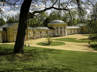 The old colonnade with a dome and a glazed gallery in the midday sun
