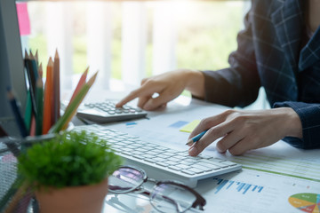 Woman using calculator while working for financial documents