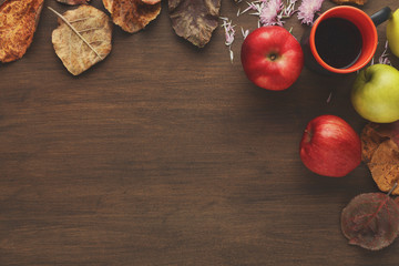 Vintage autumn border from apples and leaves on wooden table