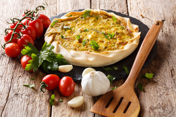 Baked golden potato pie with vegetables, bacon and parsley close-up. horizontal