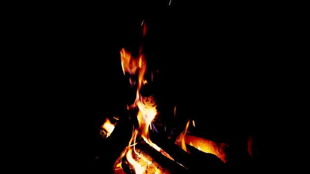 Close up fire burning in the fireplace. Video of fire flames over dark background