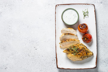 Chicken steak with yogurt sauce top view.