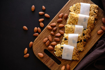 Super food breakfast bars with oats,sesame, sunflower seeds, honey and nuts on brown wooden background. Top view. Flat lay. Healthy eating concept