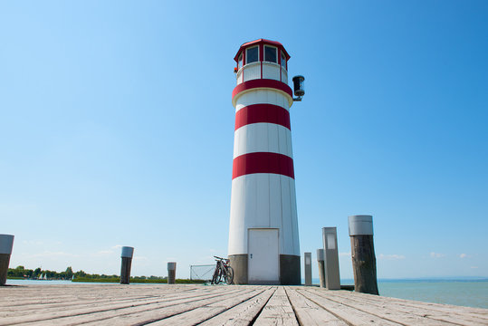 lighthouse at day with a wooden dock in `Podersdorf´ austria - low angle view